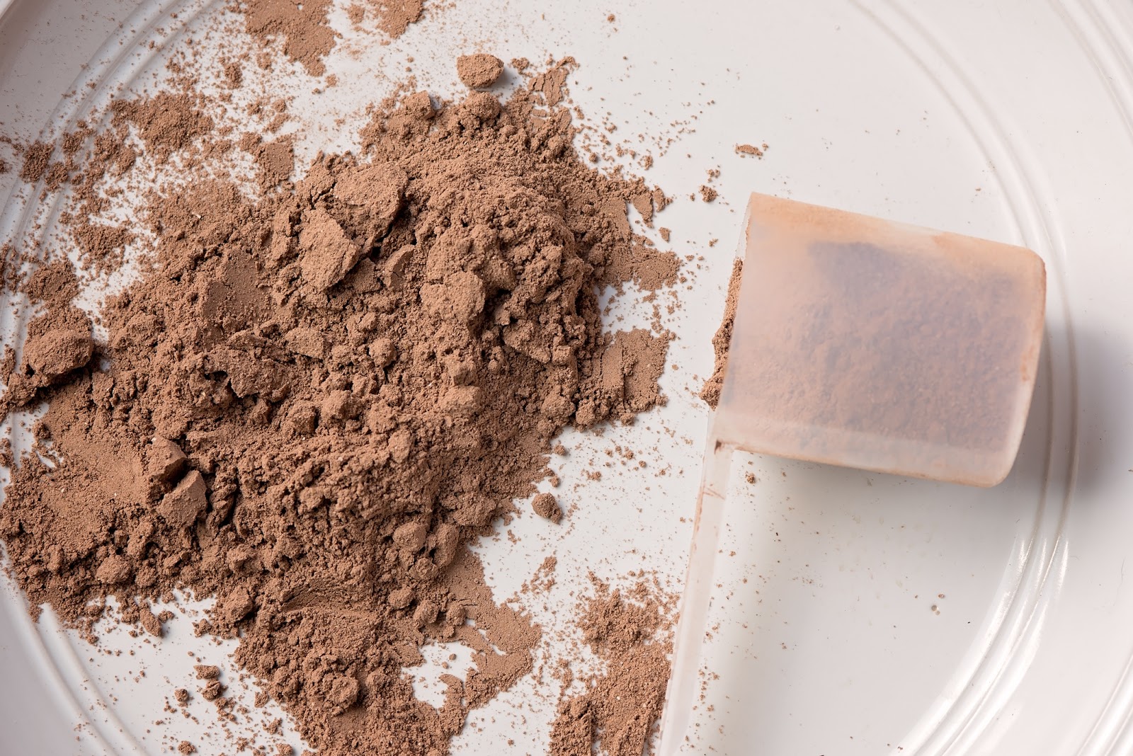 Meal replacement shake powder on a plate with scoop